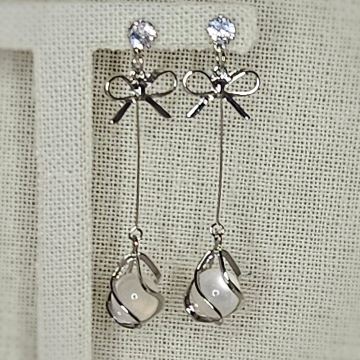 Silver bow drop earrings
