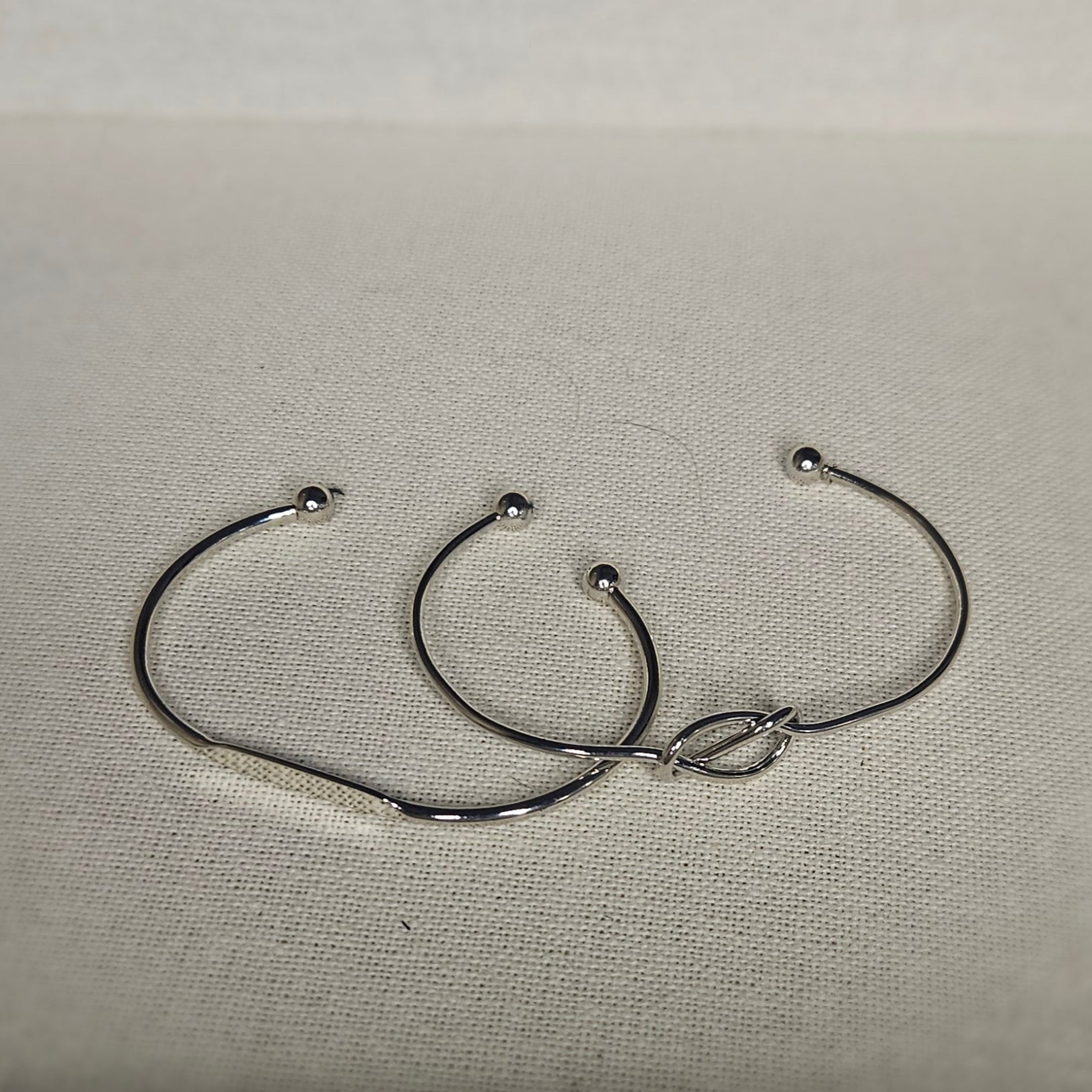 Pair of silver adjustable bangles