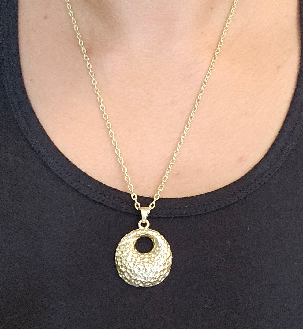 Gold necklace with round textured pendant